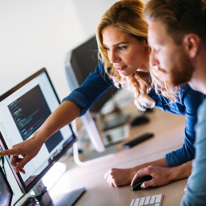 Two people looking at a computer screen